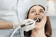 Dentist examining patient's teeth during professional dental checkup in clinical setting.