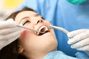 Patient receiving dental examination with dentist using tools in clinical setting