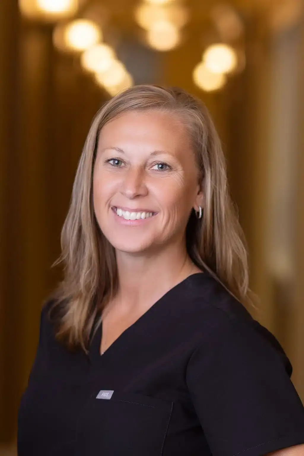 Female dental team member smiling at Winchester, VA dental practice.