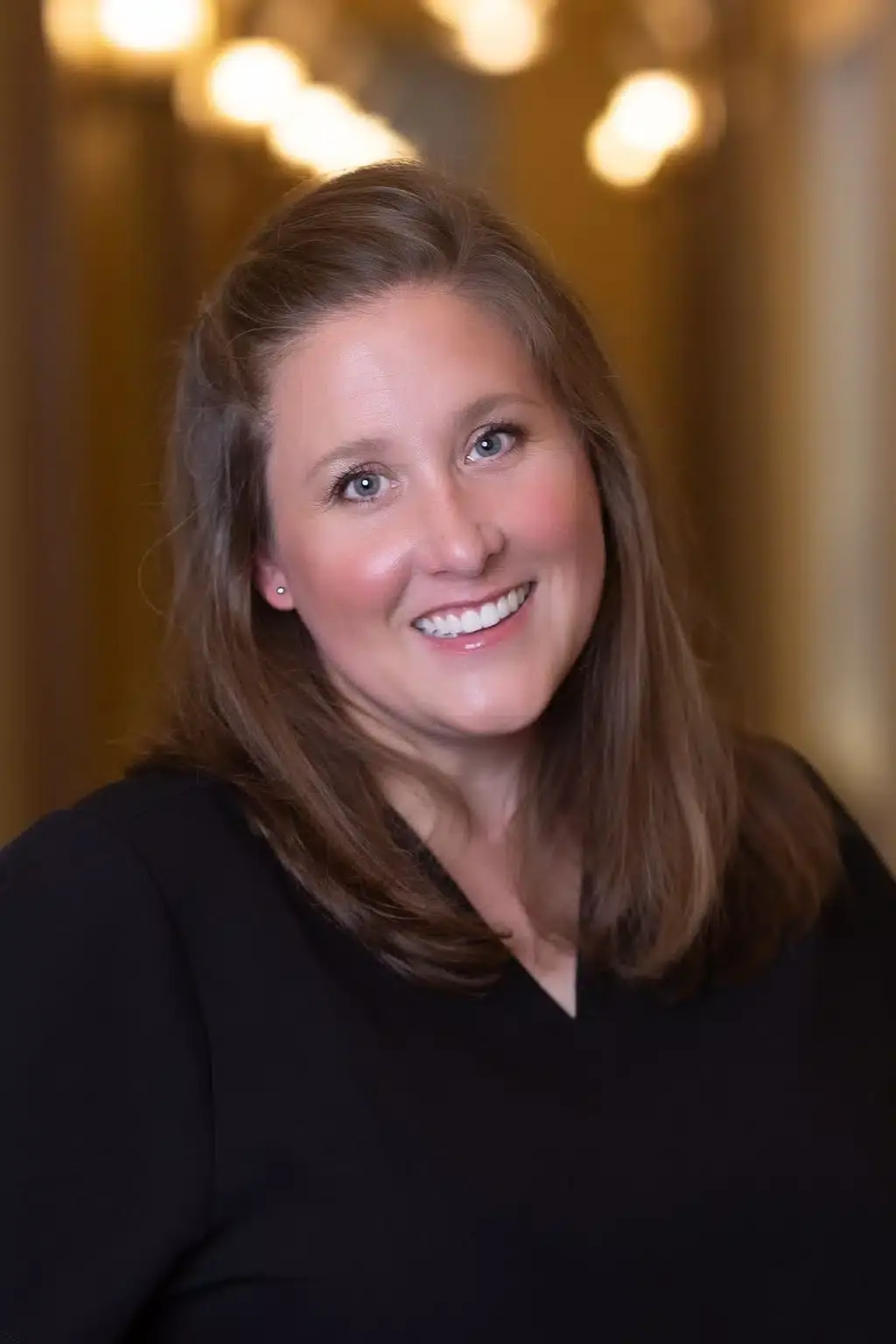 Professional female team member smiling at Winchester dental practice.