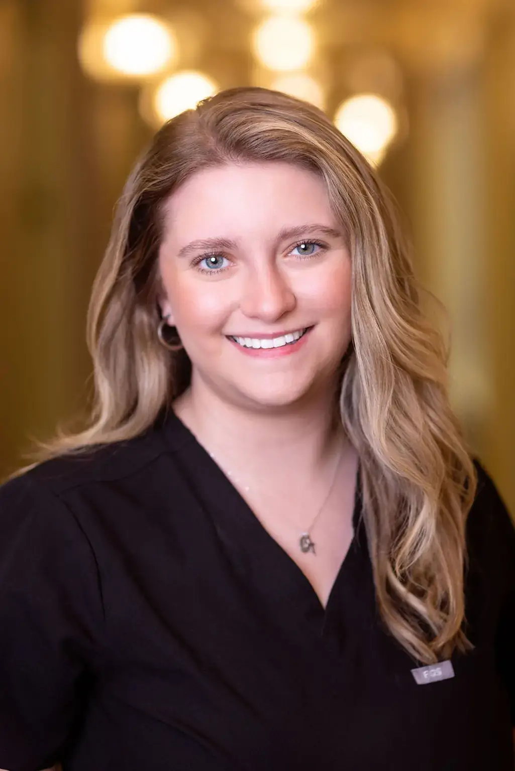 Professional female dental team member smiling at Winchester, VA practice.