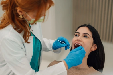 Dentist applying BioClear veneers to a patient's teeth