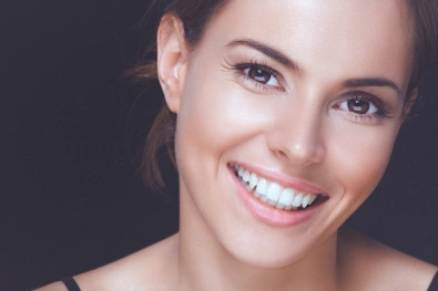 Woman smiling after cosmetic dental treatment
