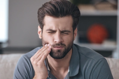 Patient experiencing tooth pain during a dental emergency