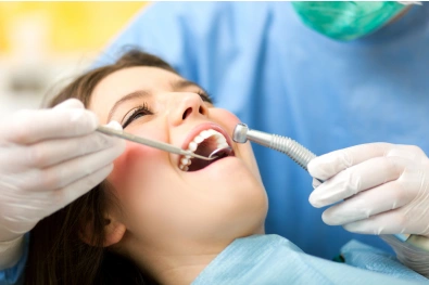 Dentist performing oral surgery on a patient