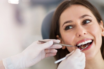 Dentist examining a patient's gums and teeth