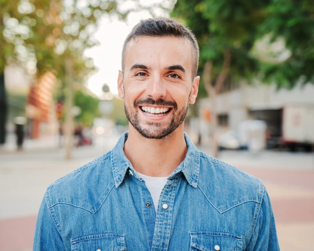 Smiling man showing bright white teeth after teeth whitening